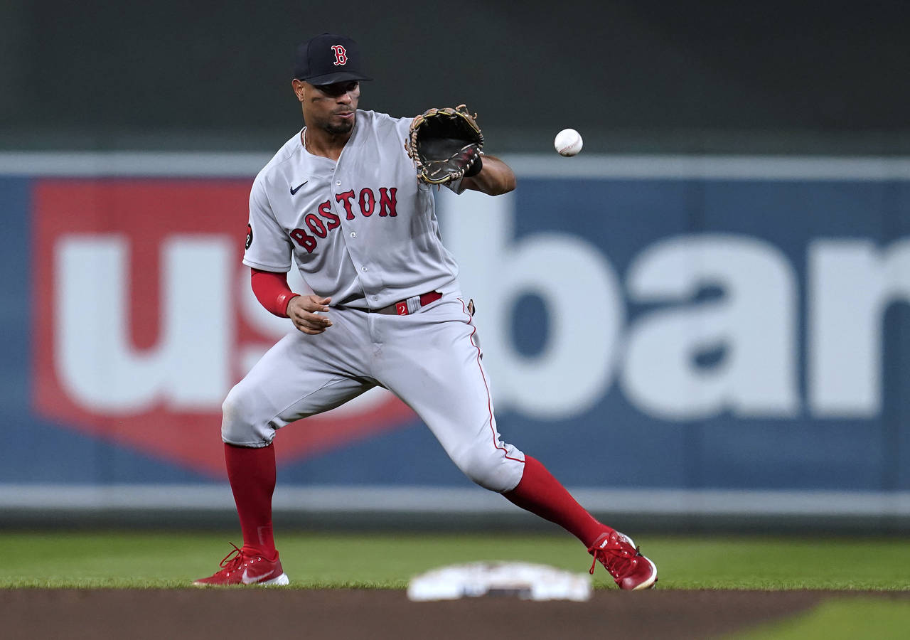 FILE - Boston Red Sox's Xander Bogaerts fields the ball hit by Minnesota Twins' Luis Arraez during ...