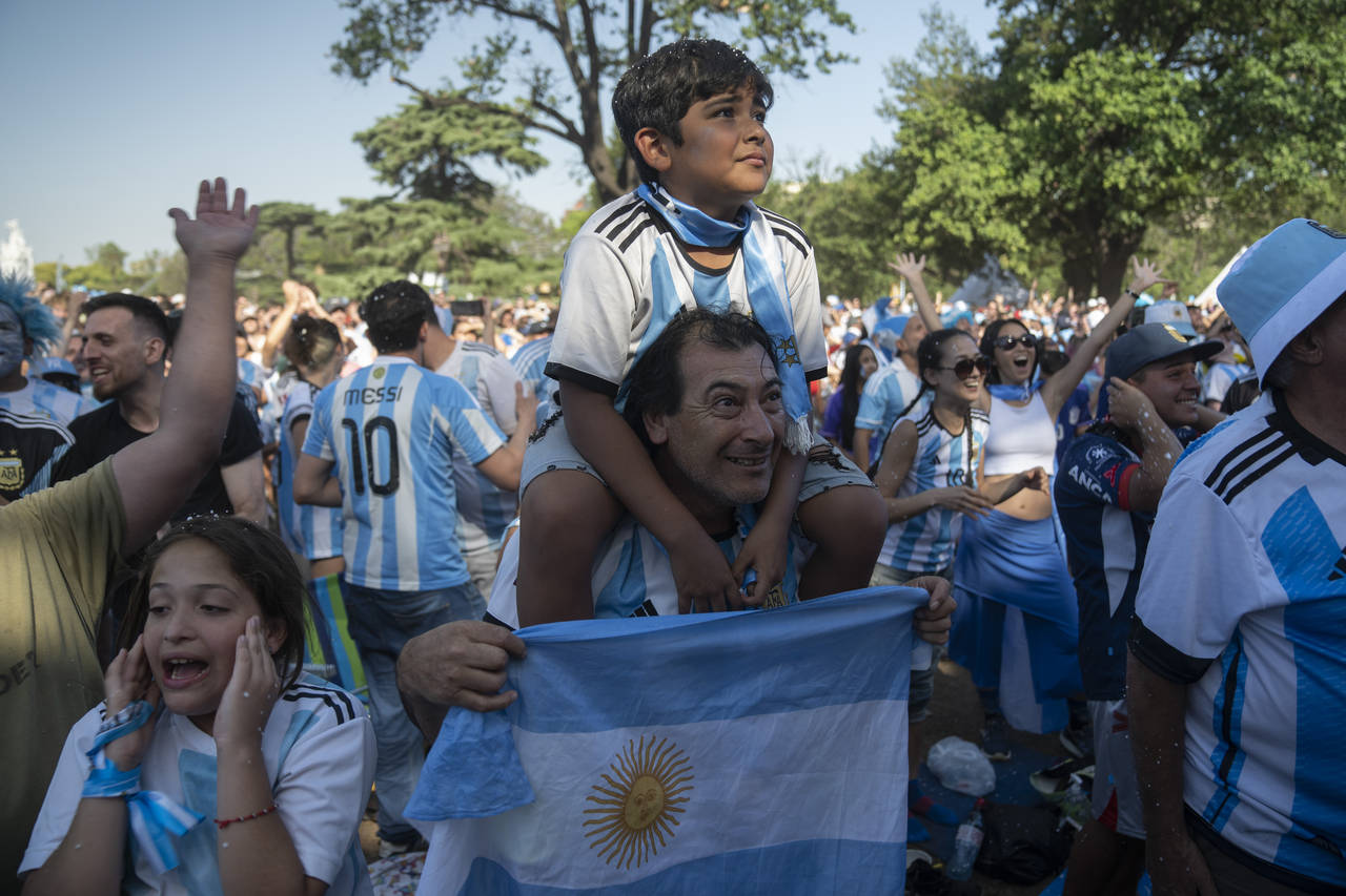 Argentina soccer fans celebrate their team's victory over Croatia in a World Cup semifinal match af...