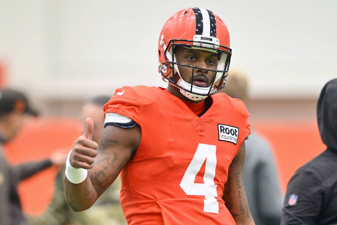 Cleveland Browns quarterback Deshaun Watson gestures on the field during an NFL football practice a...