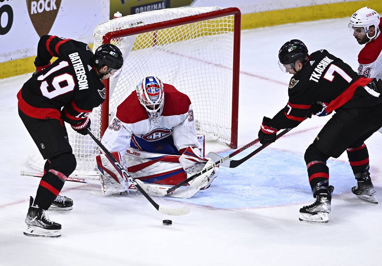 Ottawa Senators right wing Drake Batherson (19) and left wing Brady Tkachuk (7) try to get a shot o...