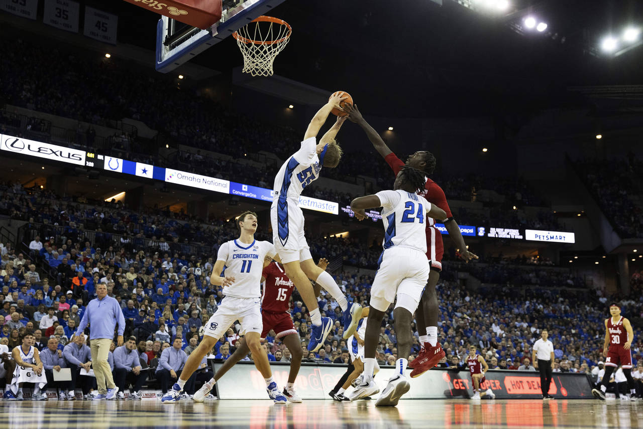 Nebraska's Juwan Gary, right, reaches for a rebound against Creighton's Ryan Kalkbrenner, from left...