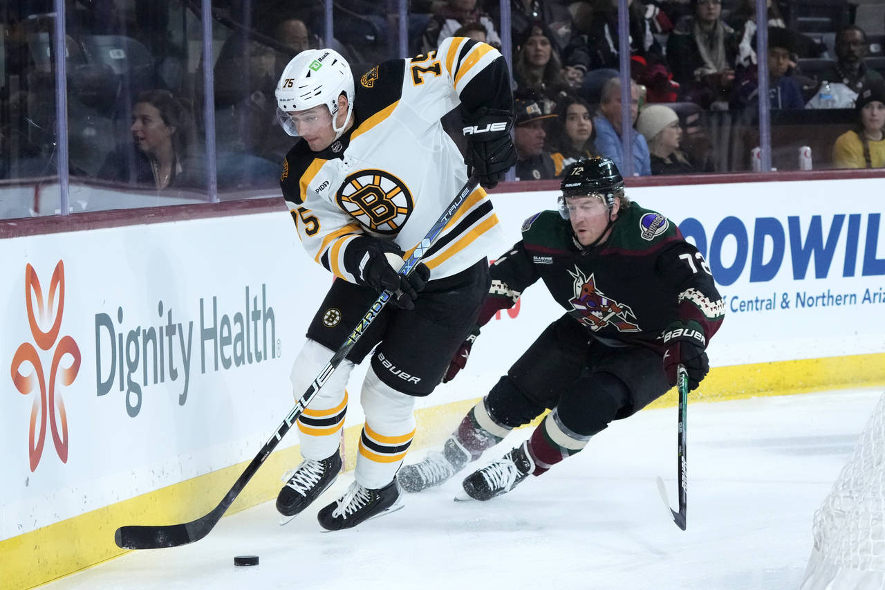 Boston Bruins defenseman Connor Clifton (75) skates with the puck against Arizona Coyotes center Tr...