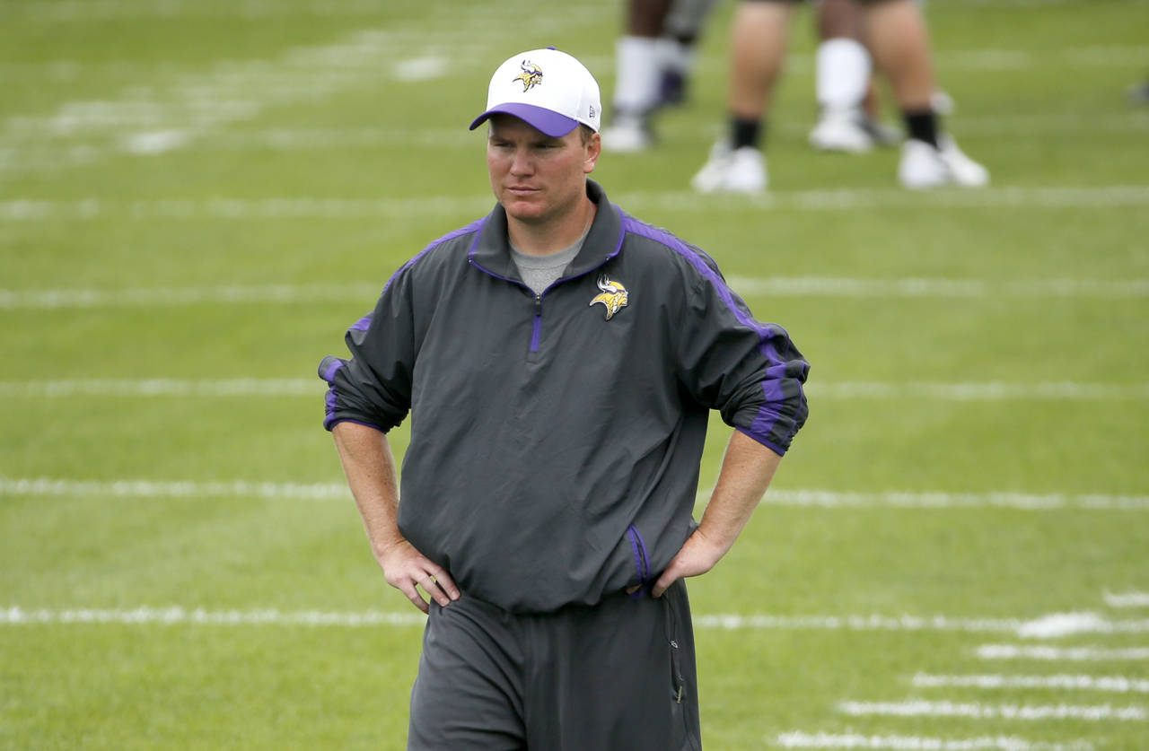 FILE - Minnesota Vikings defensive backs coach Adam Zimmer watches practice at an NFL football trai...