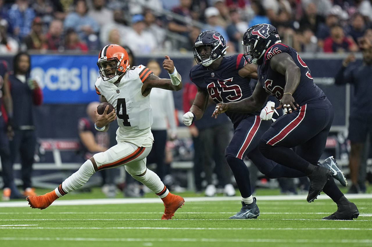 Cleveland Browns quarterback Deshaun Watson (4) evades Houston Texans guard Kenyon Green (59) and d...