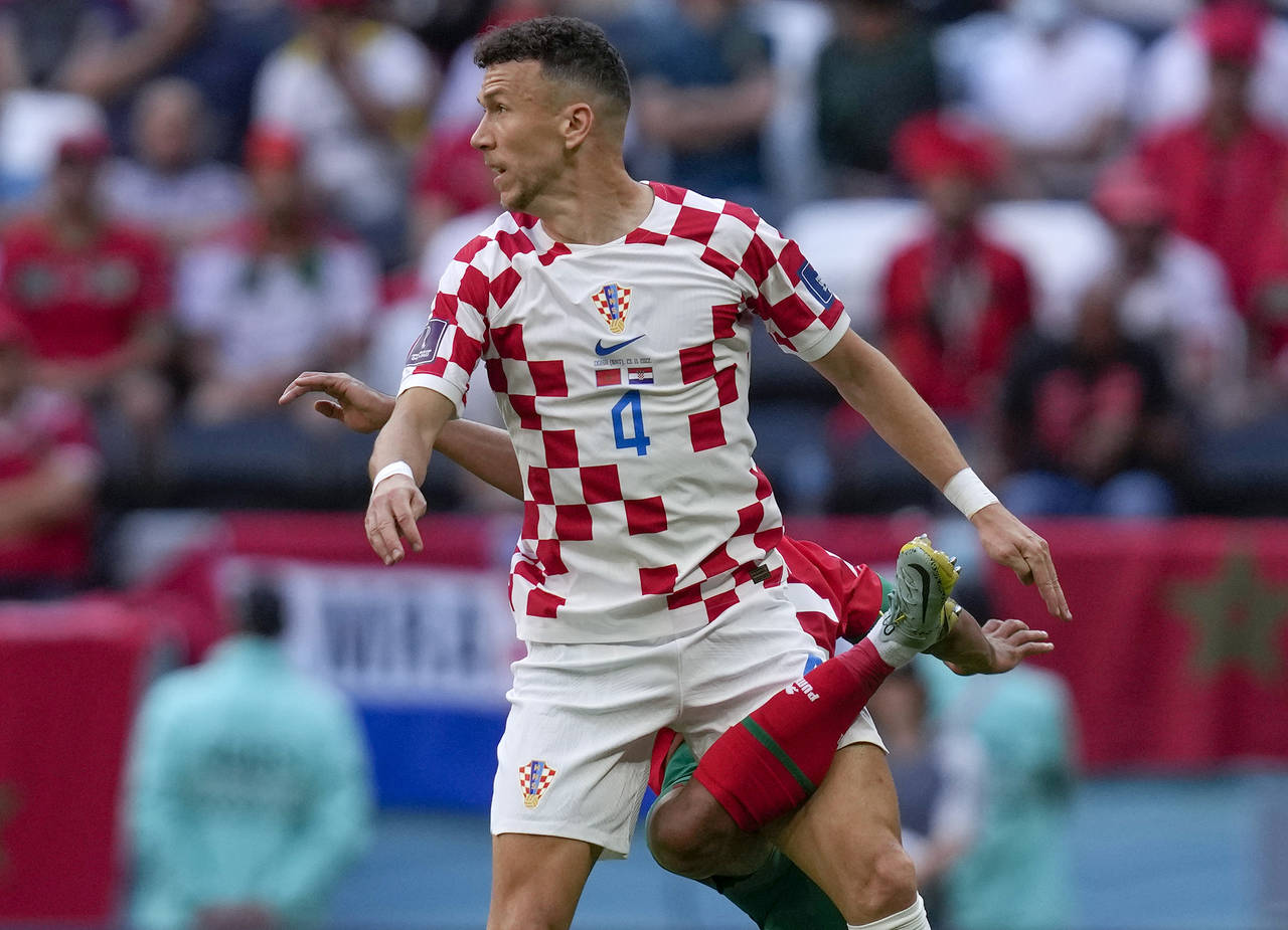 Croatia's Ivan Perisic, top, vies for a ball with Morocco's Achraf Hakimi during the World Cup grou...