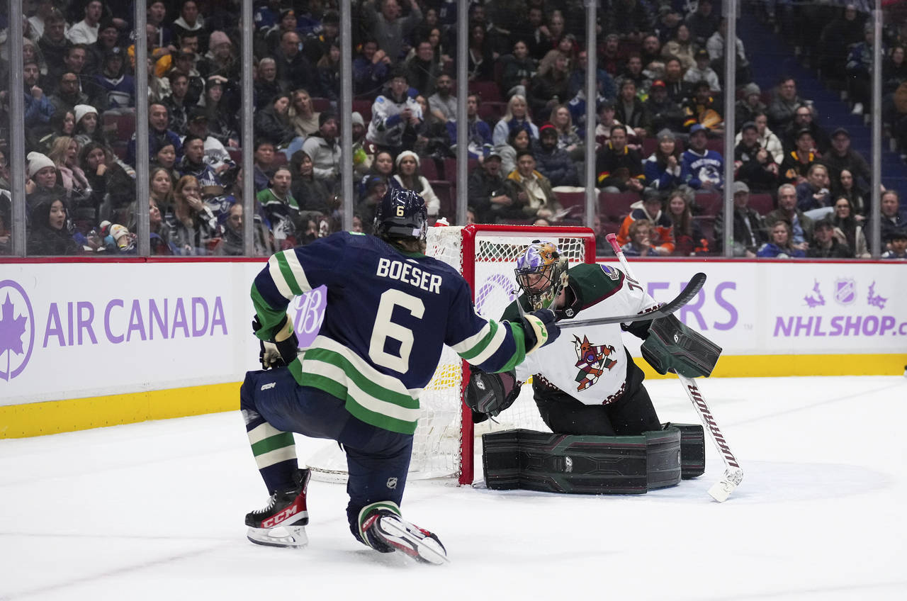 Vancouver Canucks' Brock Boeser (6) scores against Arizona Coyotes goalie Karel Vejmelka during the...