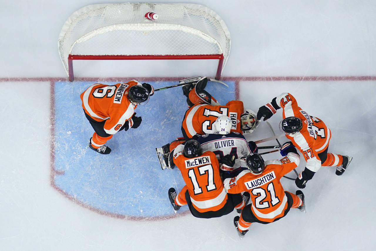 Columbus Blue Jackets' Mathieu Olivier (24) battles for a rebound against Philadelphia Flyers' Tony...