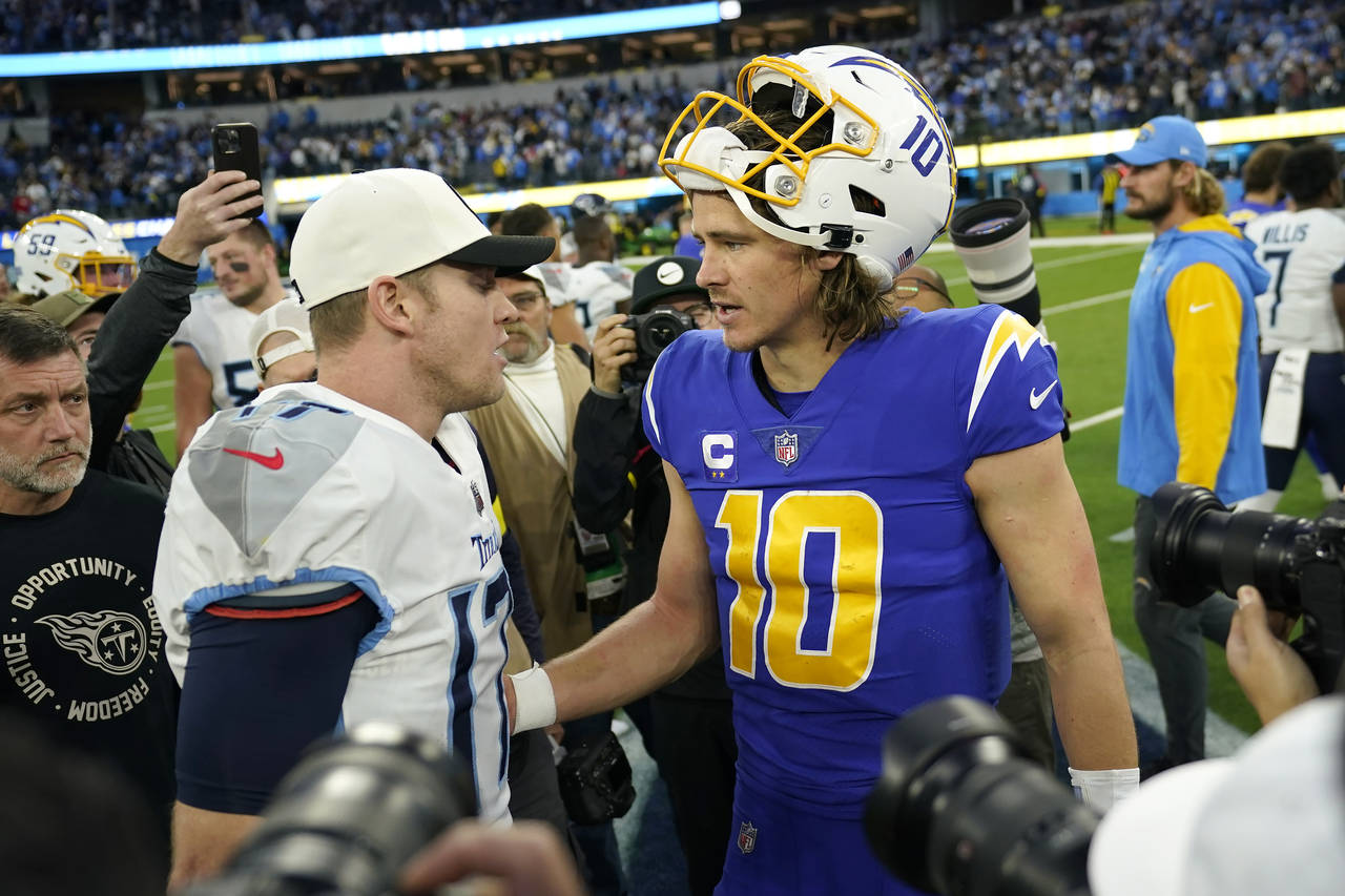 Tennessee Titans quarterback Ryan Tannehill, left, greets Los Angeles Chargers quarterback Justin H...