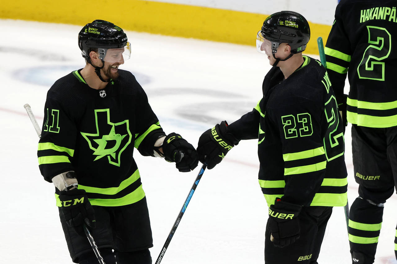 Dallas Stars center Luke Glendening (11) congratulates defenseman Esa Lindell (23) on his empty-net...