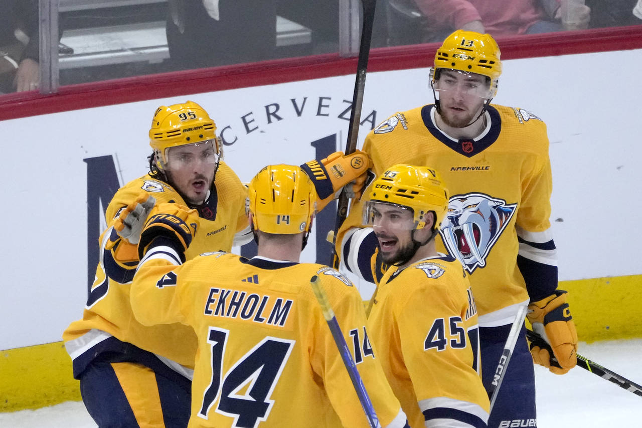 Nashville Predators' Matt Duchene, left, celebrates his goal with Mattias Ekholm (14) Alexandre Car...