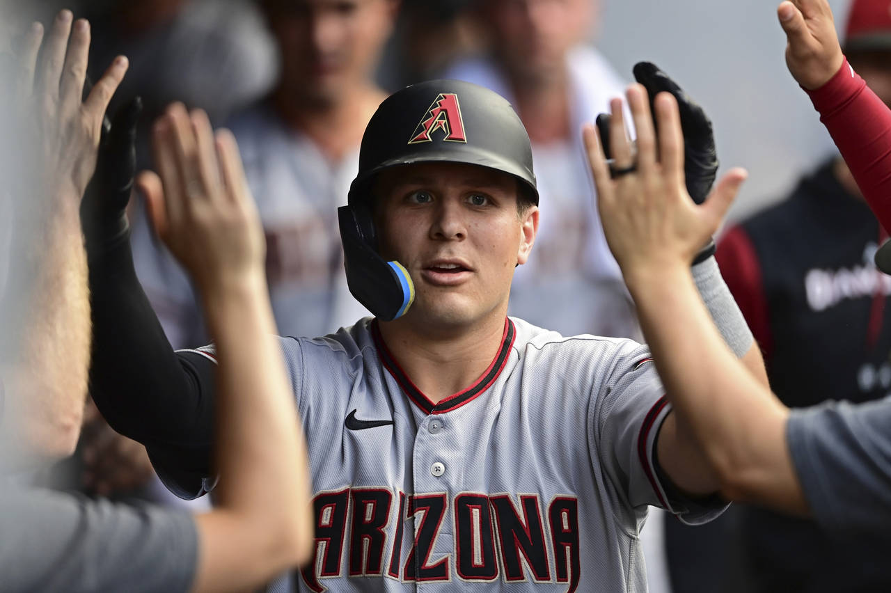 FILE -Arizona Diamondbacks' Daulton Varsho is congratulated int he dugout after hitting a solo home...