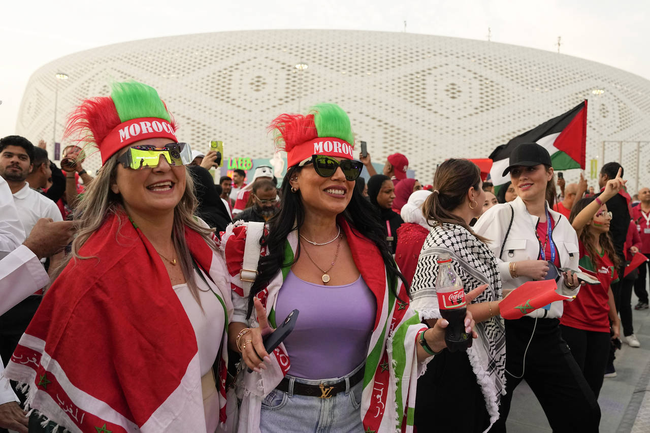 FILE - Female Morocco fans arrive at the stadium before the World Cup quarterfinal soccer match bet...