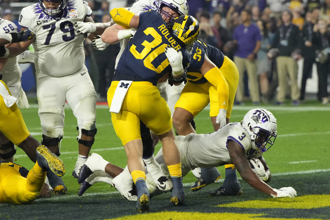 TCU running back Emari Demercado (3) scores a touchdown against Michigan during the second half of ...