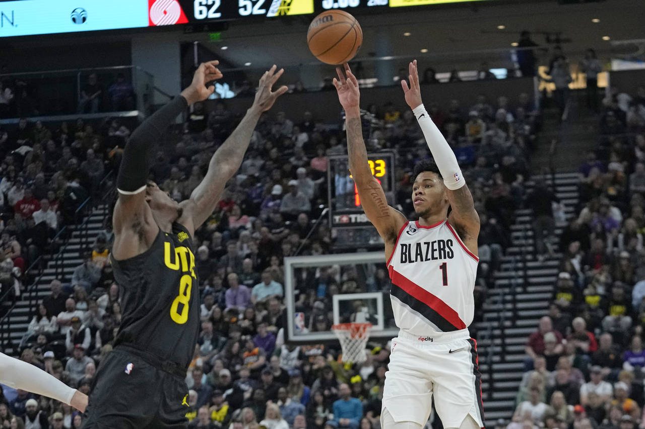 Portland Trail Blazers guard Anfernee Simons (1) shoots as Utah Jazz forward Jarred Vanderbilt (8) ...
