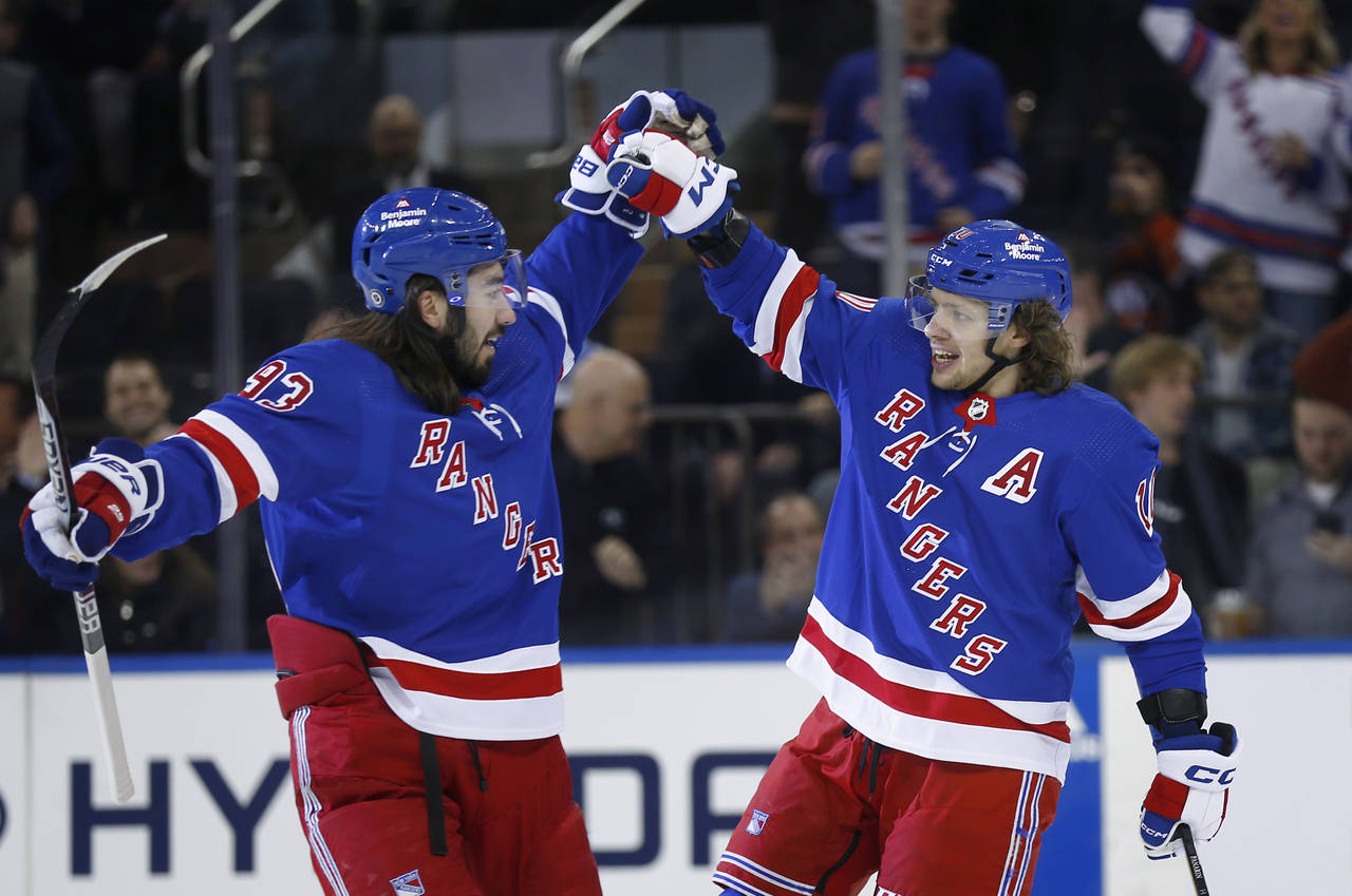 New York Rangers center Mika Zibanejad, left, congratulates Artemi Panarin after Panarin's goal aga...