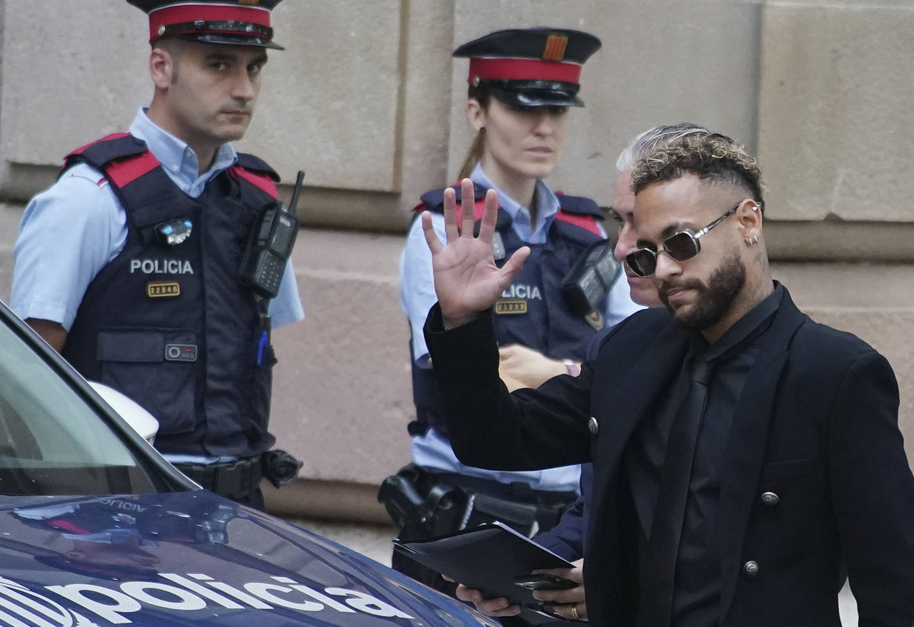 FILE - Former FC Barcelona player Neymar who now plays for Paris Saint-Germain waves on arrival at ...