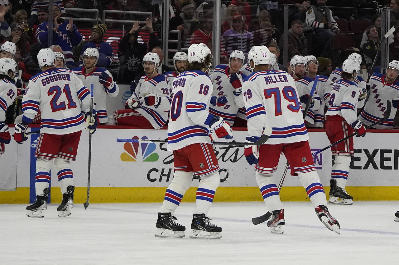 New York Rangers defenseman Jacob Trouba (8), back right, celebrates his goal against the Chicago B...