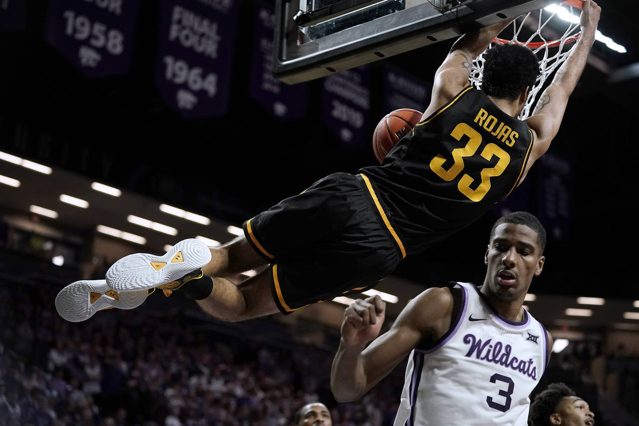 Wichita State forward James Rojas (33) gets past Kansas State forward David N'Guessan (3) to dunk t...