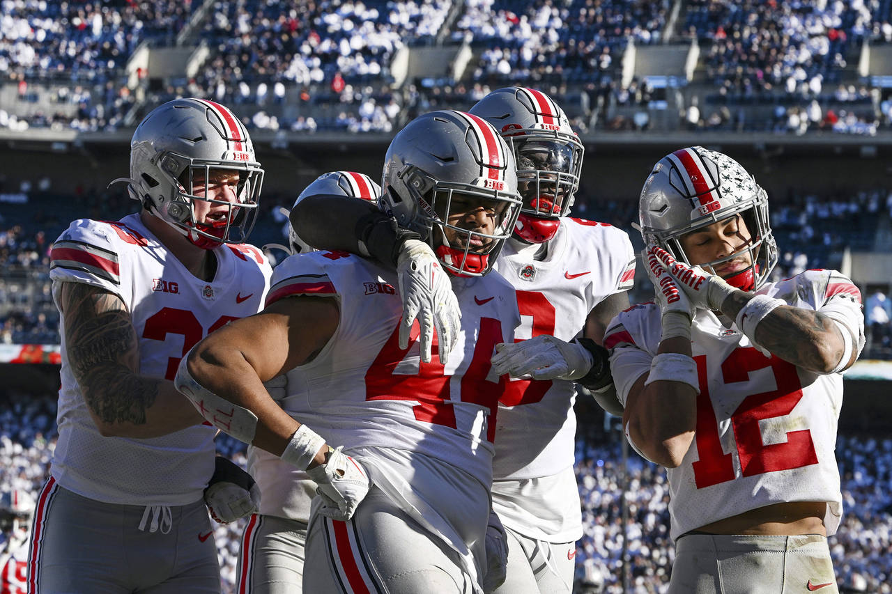 FILE0 Ohio State defensive end J.T. Tuimoloau (44) celebrates with his teammates Jack Sawyer (33), ...