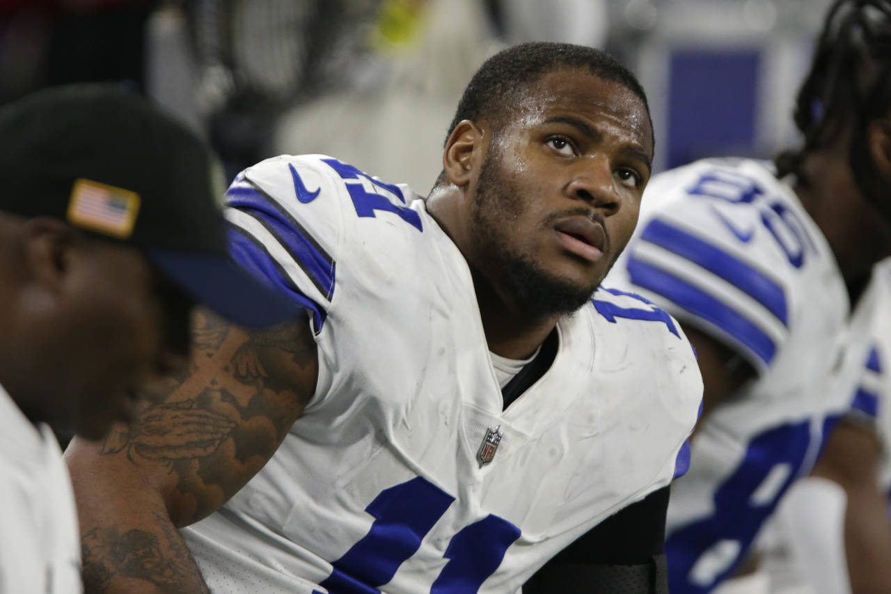 Dallas Cowboys linebacker Micah Parsons sits on the bench during the first half of an NFL football ...