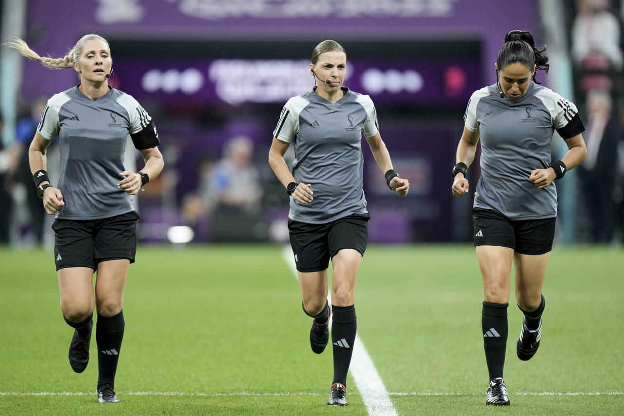 Referee Stephanie Frappart, center, assistants referee Neuza Back, left, and Karen Diaz warm up pri...