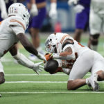 
              Texas defensive back Jerrin Thompson (28) intercepts a pass against the Washington during the first half of the Alamo Bowl NCAA college football game in San Antonio, Thursday, Dec. 29, 2022. (AP Photo/Eric Gay)
            