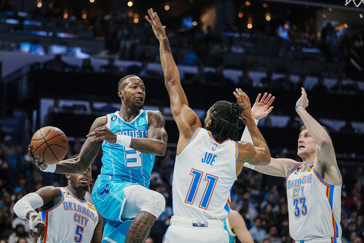 Charlotte Hornets guard Terry Rozier (3) looks to pass the ball around Oklahoma City Thunder guard ...