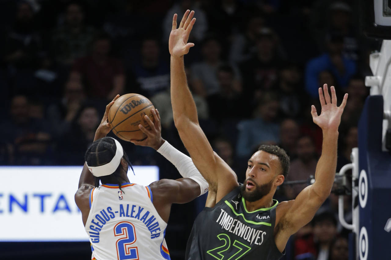 Oklahoma City Thunder guard Shai Gilgeous-Alexander (2) shoots as Minnesota Timberwolves center Rud...