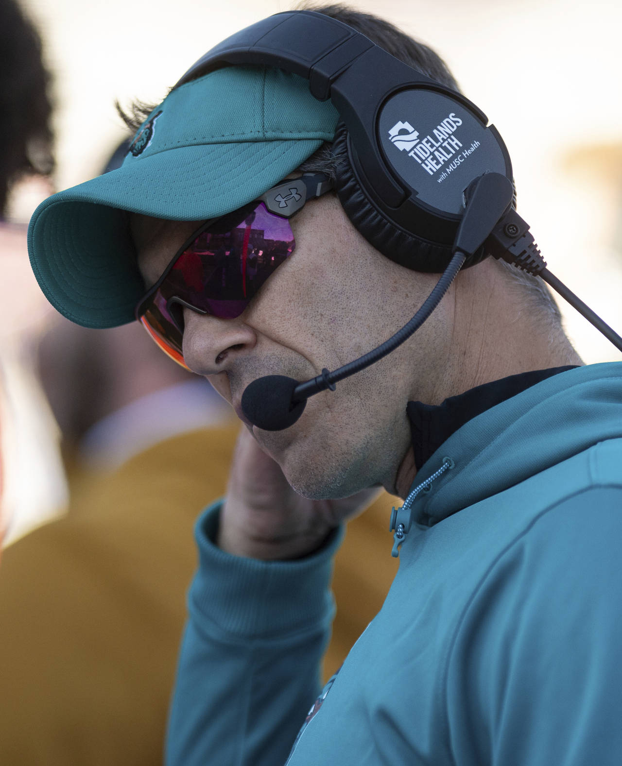 Coastal Carolina head coach Jamey Chadwell talks over his headset during the first half of an NCAA ...