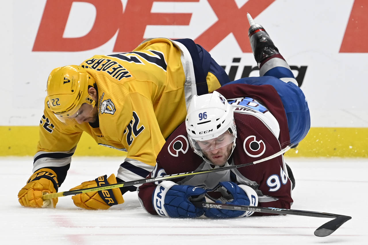 Nashville Predators right wing Nino Niederreiter (22) collides with Colorado Avalanche right wing M...