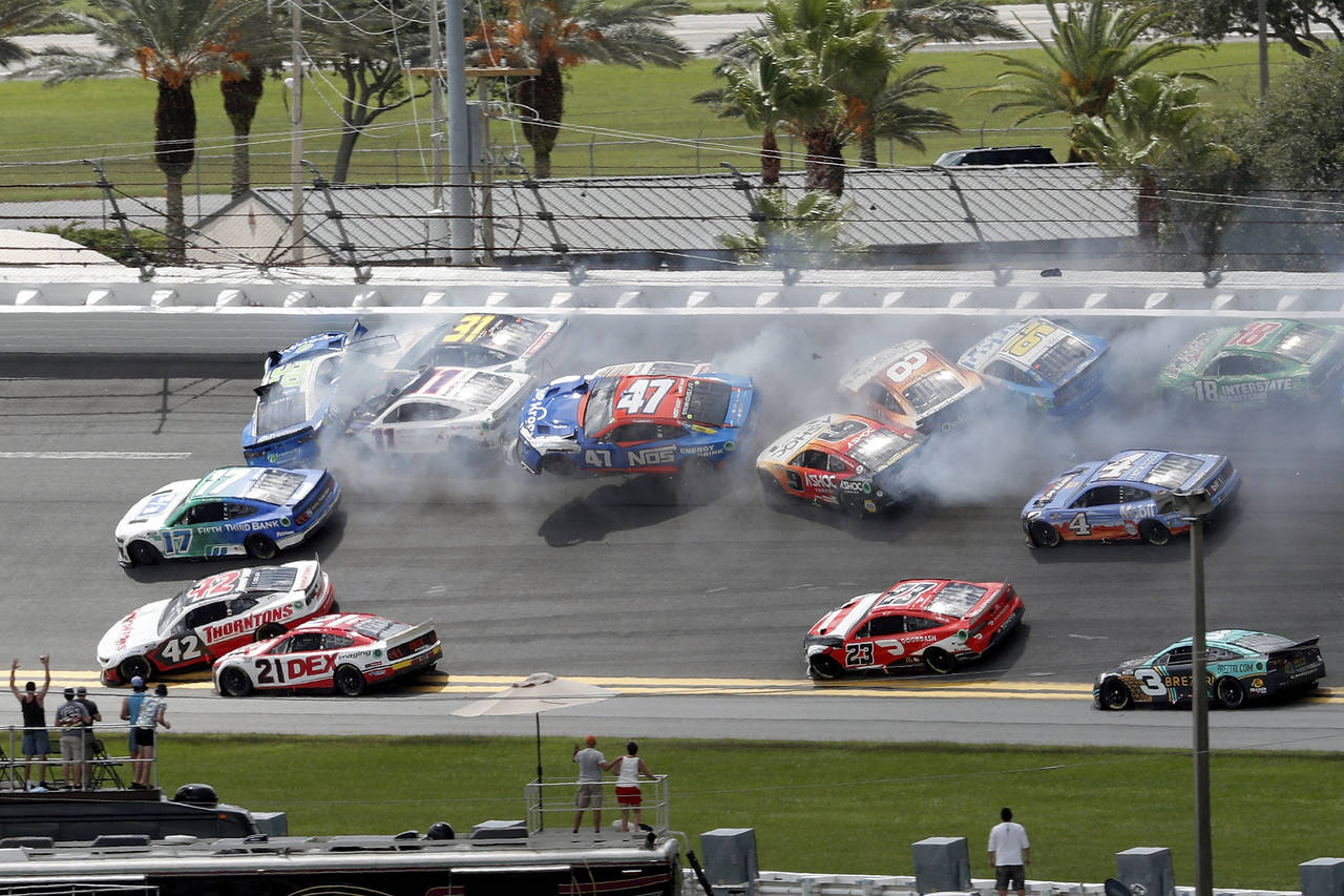 FILE - Chris Buescher (17), Daniel Suarez (99), Denny Hamlin (11), Justin Haley (31), Ricky Stenhou...