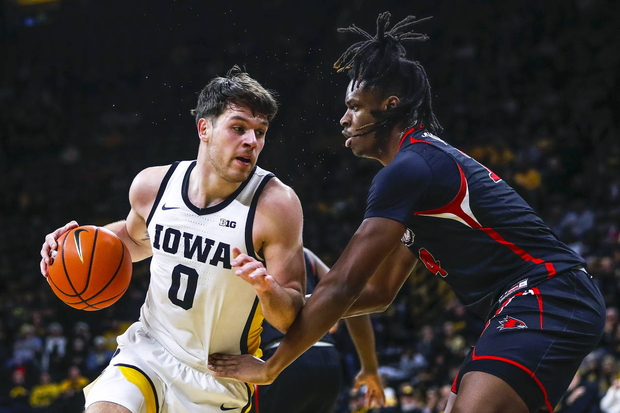 Iowa forward Filip Rebraca, left, battles against Southeast Missouri State center Nate Johnson, rig...