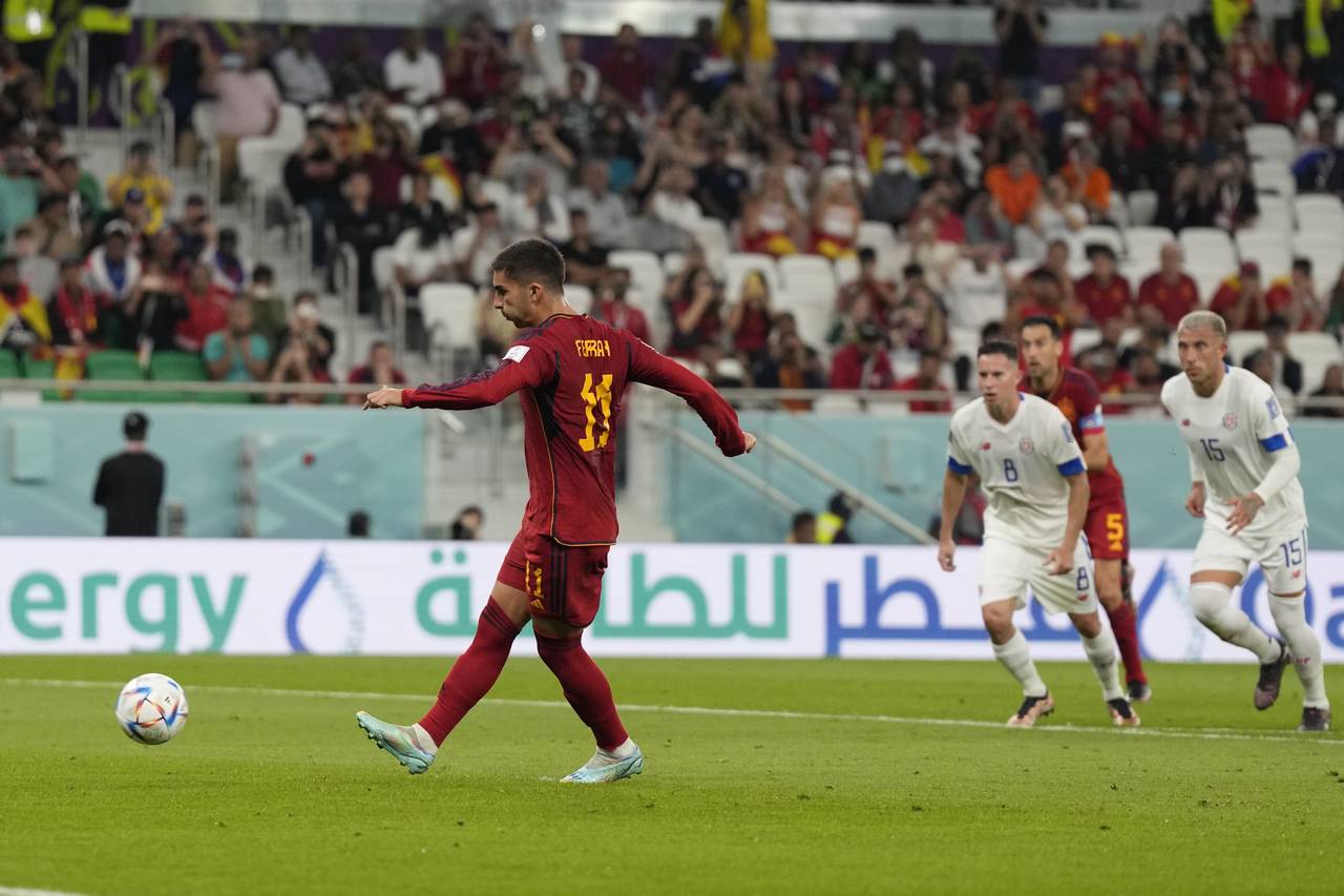 Spain's Ferran Torres scores a penalty, the third goal of his team, during the World Cup group E so...