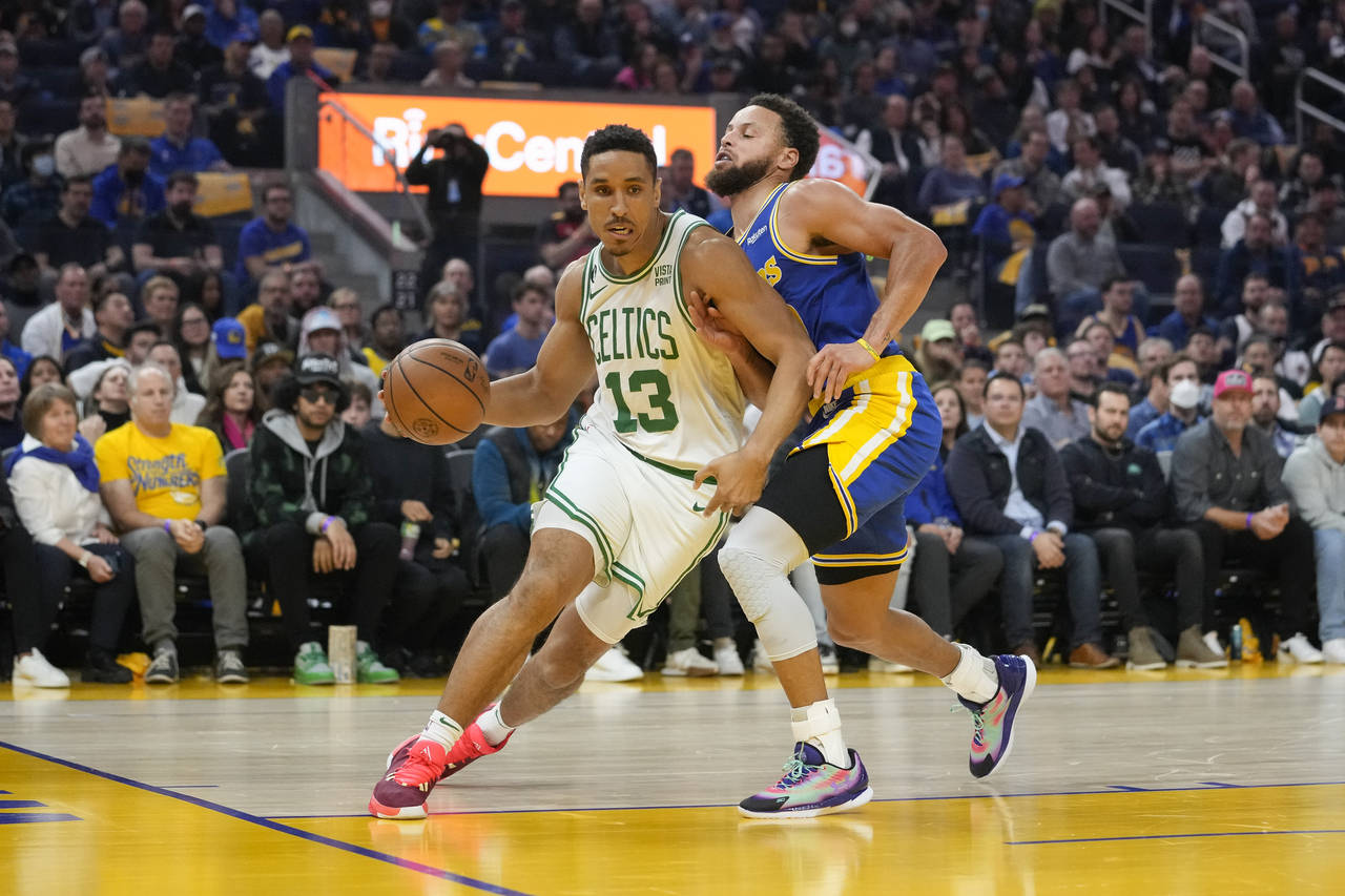 Boston Celtics guard Malcolm Brogdon (13) drives to the basket against Golden State Warriors guard ...