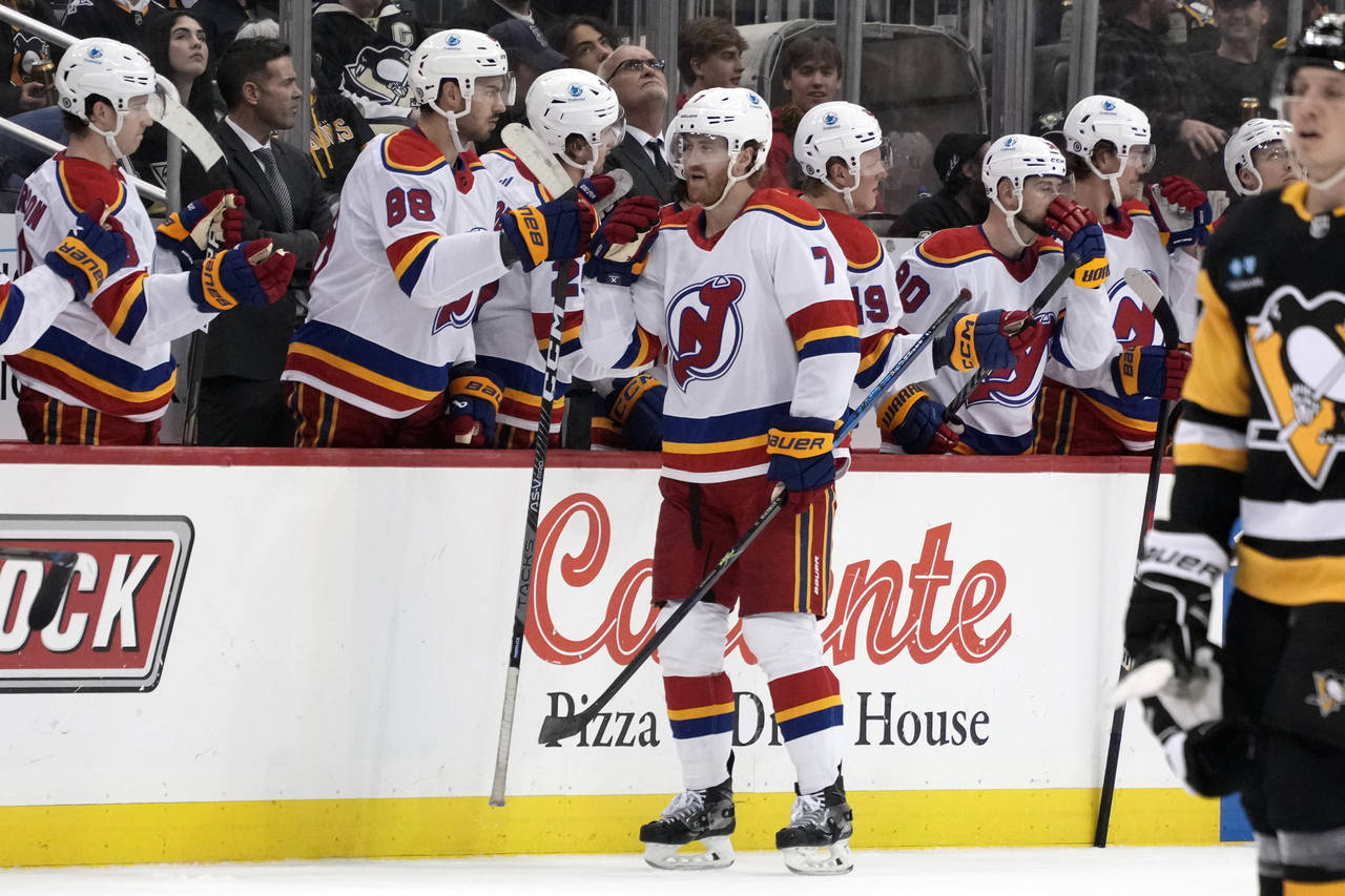 New Jersey Devils' Dougie Hamilton (7) returns to the bench after scoring against the Pittsburgh Pe...