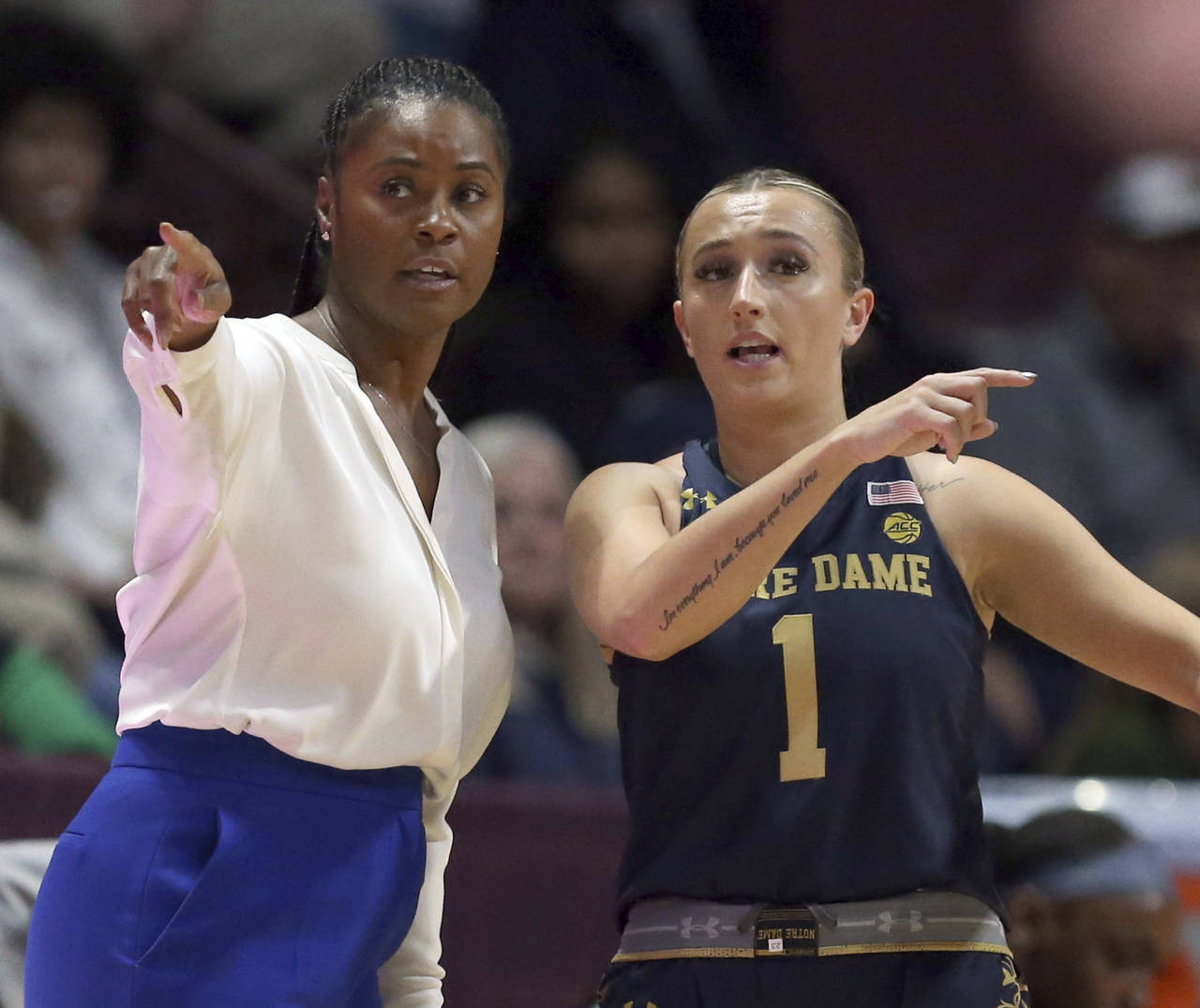 Notre Dame head coach Niele Ivey, left, talks with Dara Mabrey (1) in the first half of an NCAA col...