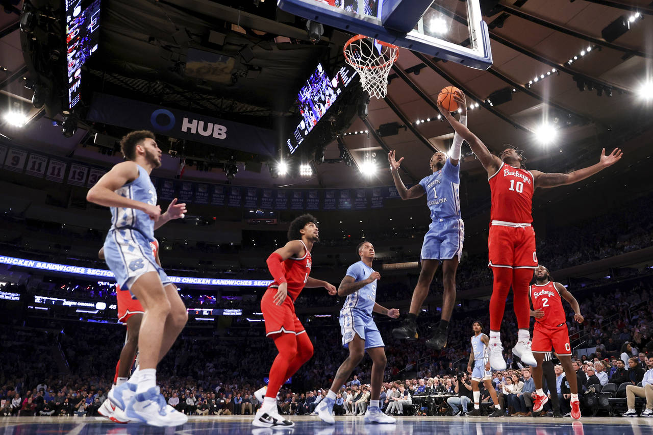 North Carolina forward Leaky Black (1) and Ohio State forward Brice Sensabaugh (10) fight for the b...