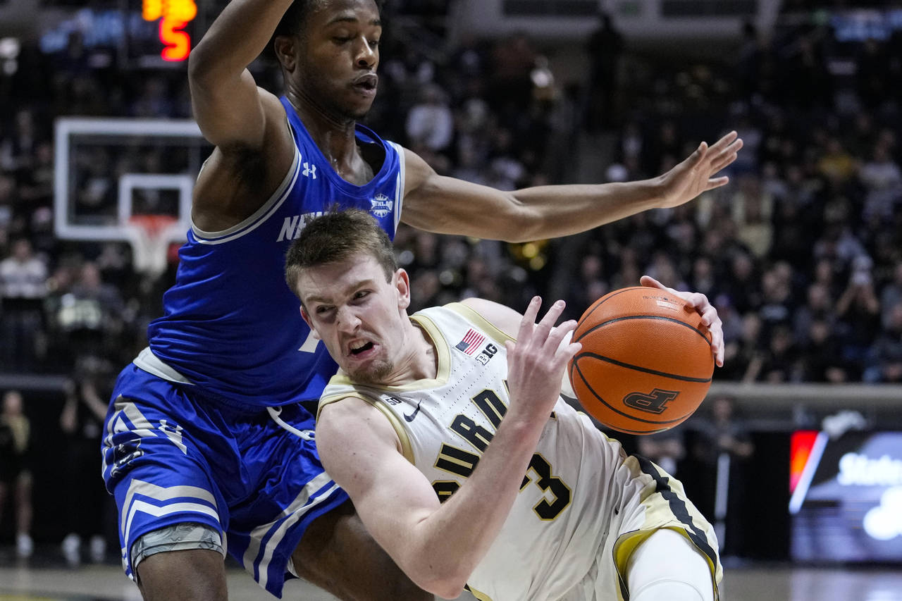 Purdue guard Fletcher Loyer (2) falls as he drives around New Orleans guard Jordan Johnson (1) duri...