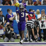 
              Washington wide receiver Taj Davis (3) celebrates after scoring a touchdown against Texas during the second half of the Alamo Bowl NCAA college football game in San Antonio, Thursday, Dec. 29, 2022. (AP Photo/Eric Gay)
            