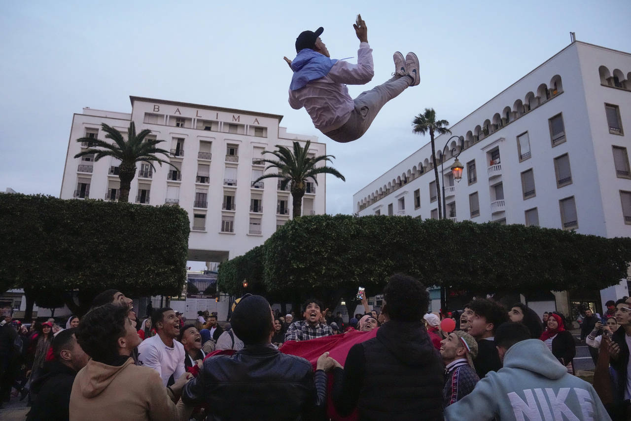 FILE - Moroccans celebrate in Rabat, Morocco, Saturday Dec. 10, 2022, after defeating Portugal in t...