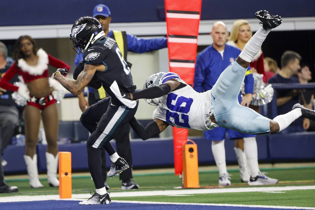 Philadelphia Eagles' DeVonta Smith catches a touchdown pass with Dallas Cowboys' DaRon Bland defend...