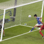 Japan beats Spain 2-1 as both teams advance at World Cup