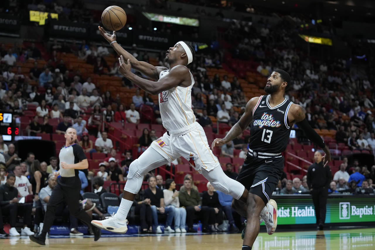 Miami Heat forward Jimmy Butler (22) goes up for a shot against Los Angeles Clippers forward Paul G...