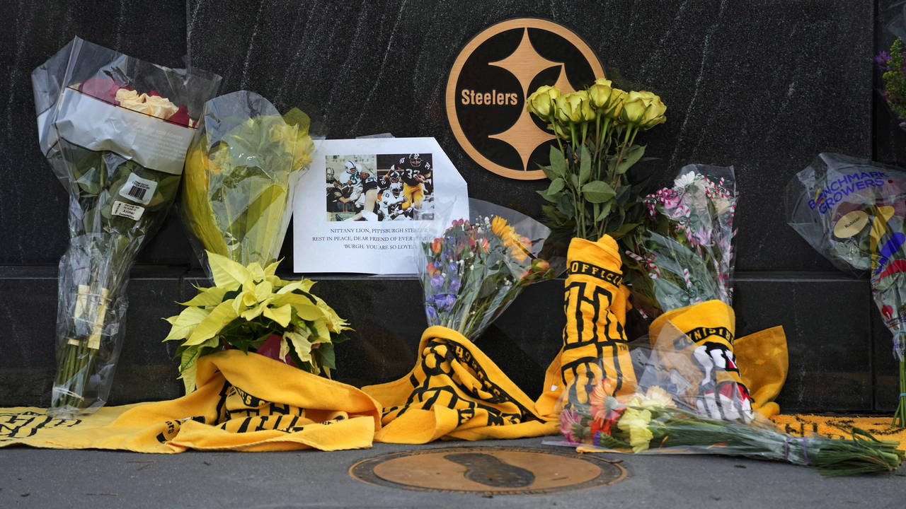 Flowers and Terrible Towels are placed at Immaculate Reception memorial outside Acrisure Stadium on...