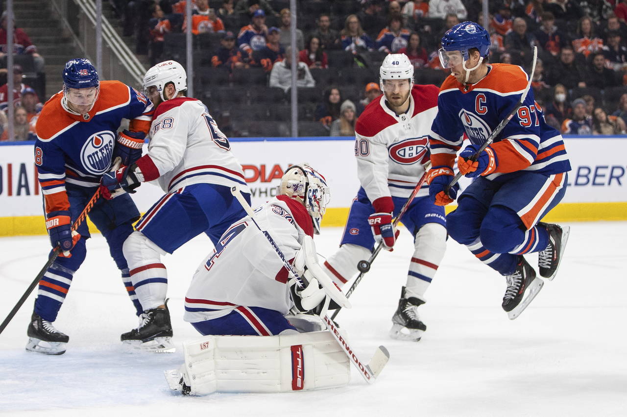 Montreal Canadiens goalie Jake Allen (34) makes the save as Edmonton Oilers' Connor McDavid (97) ju...