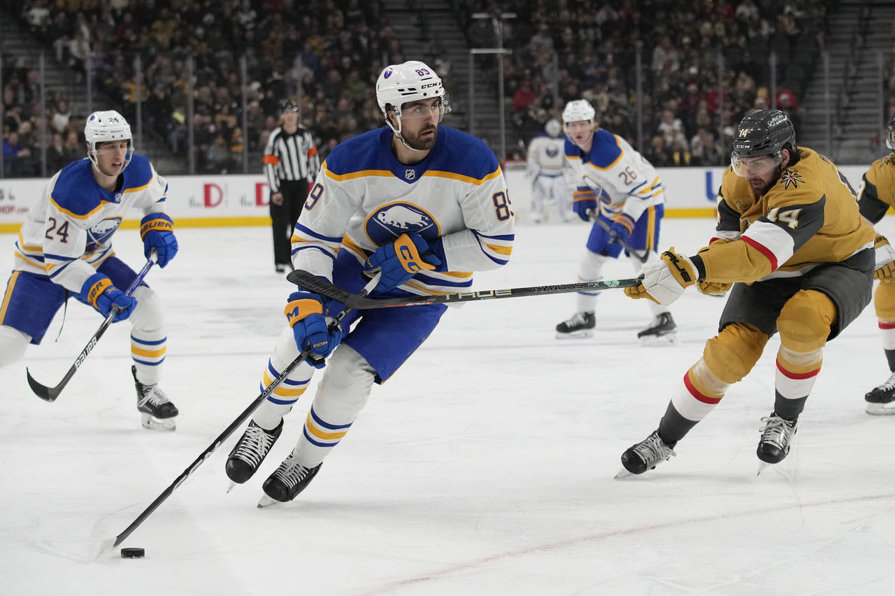 Buffalo Sabres right wing Alex Tuch (89) skates around Vegas Golden Knights defenseman Nicolas Hagu...