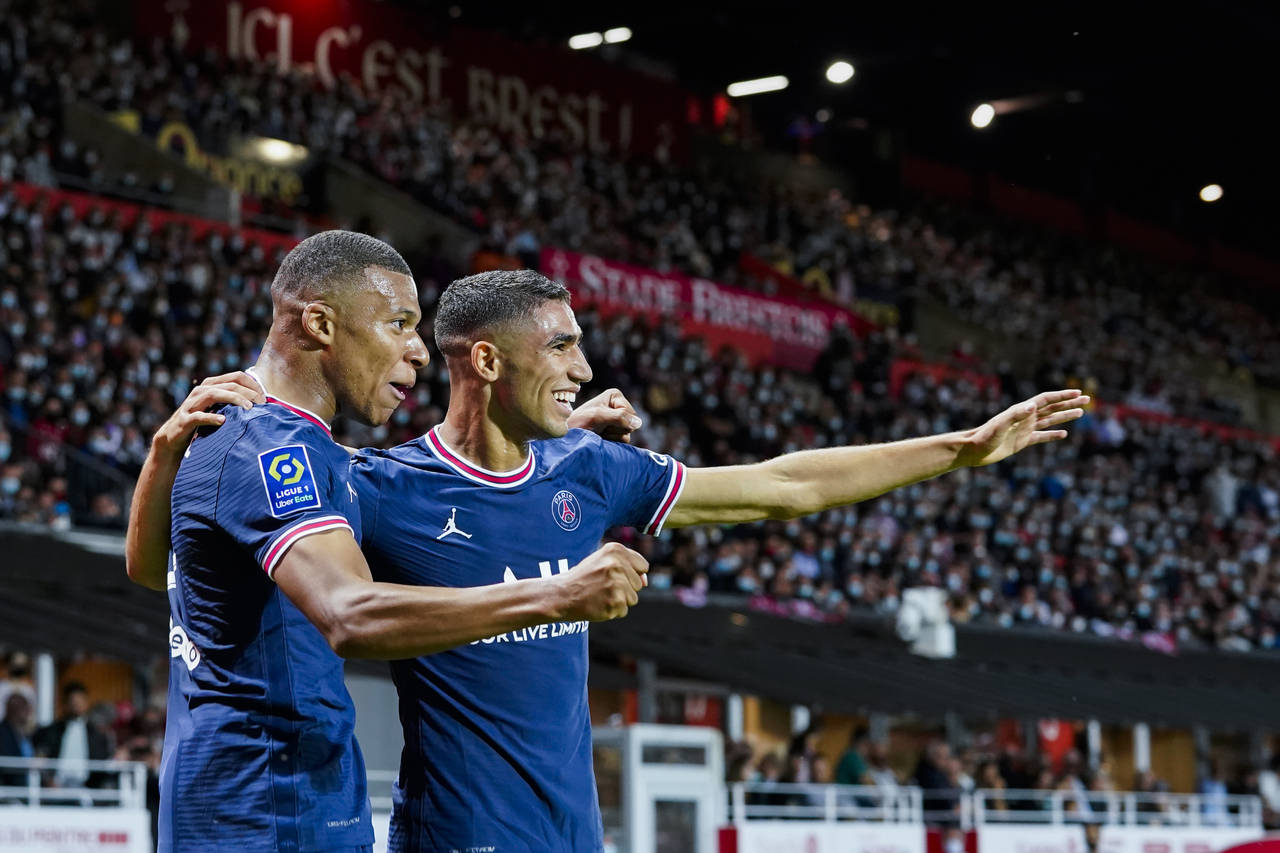 FILE - PSG's Kylian Mbappe, left, celebrates with teammate PSG's Achraf Hakimi after scoring his si...