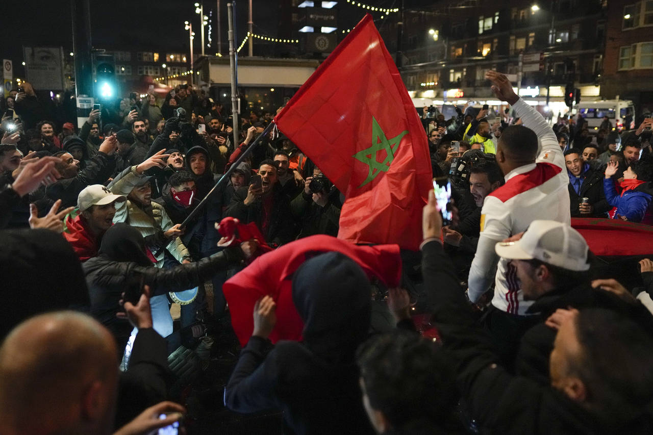 Morocco fans celebrate their team's victory against Spain in the World Cup round of 16 soccer match...
