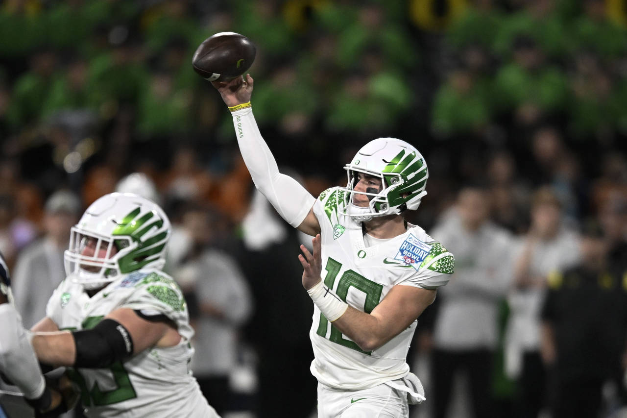 Oregon quarterback Bo Nix (10) passes during the first half of the Holiday Bowl NCAA college footba...