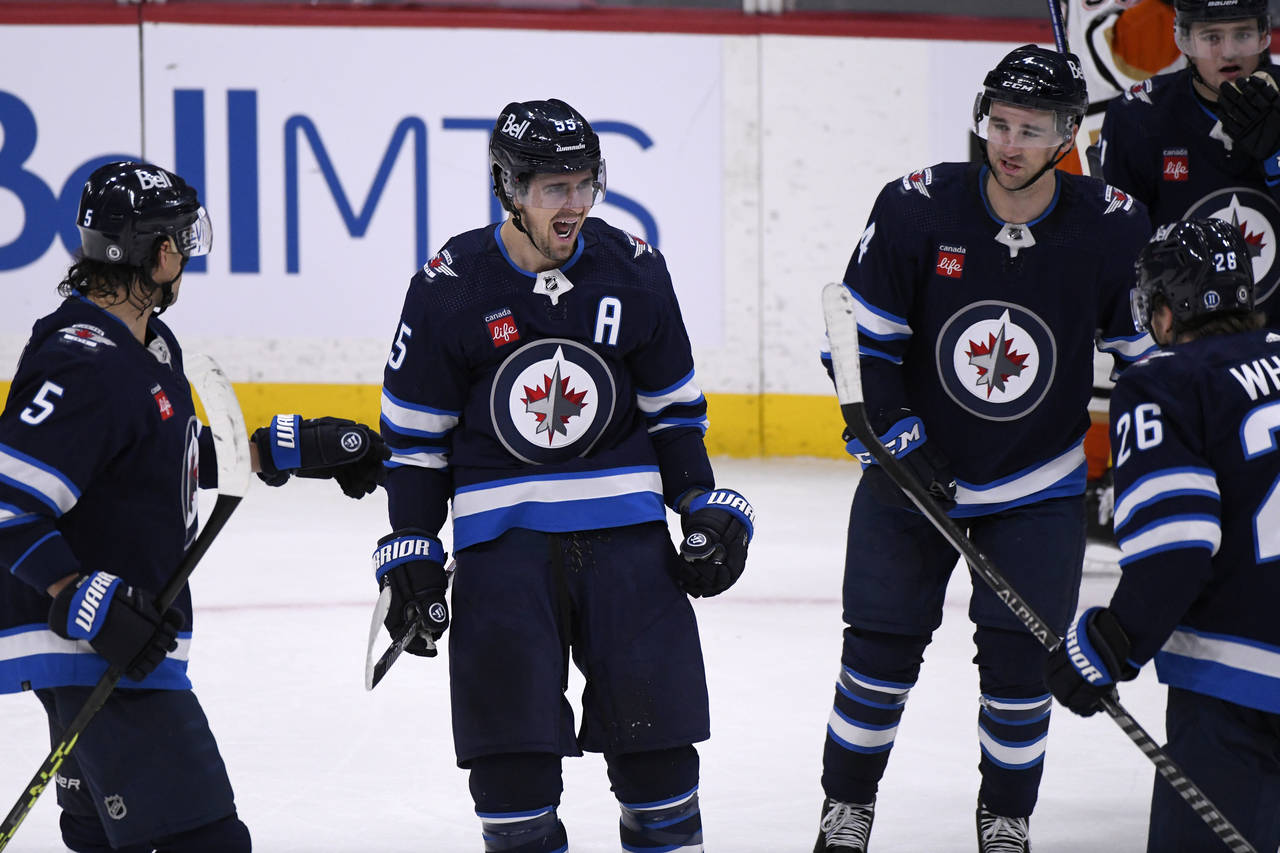 Winnipeg Jets' Mark Scheifele (55) celebrates his goal against the Anaheim Ducks with teammates dur...